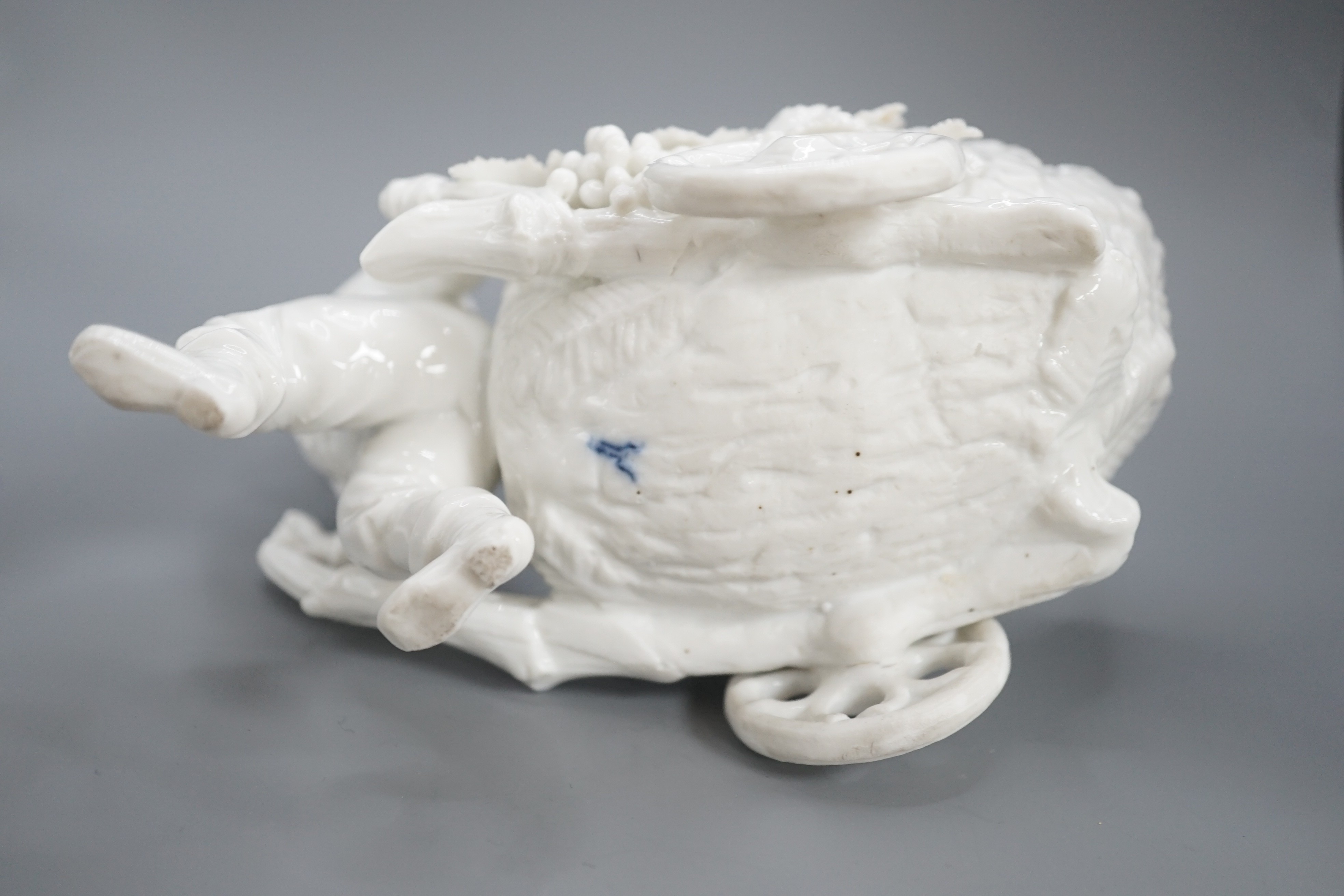 A pair of Continental porcelain cherub candlesticks, 13.5cm, a figural bonbon and a Derby figure